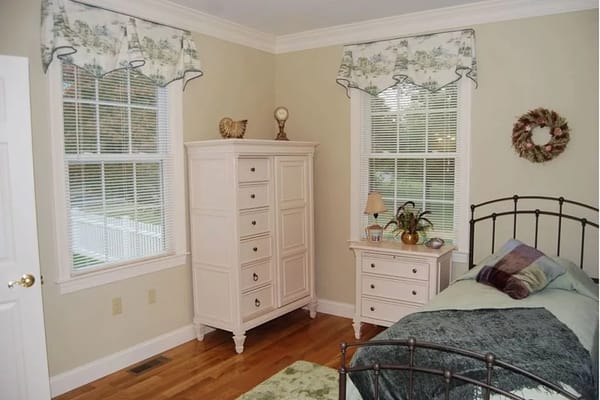 A cozy resident bedroom with natural light