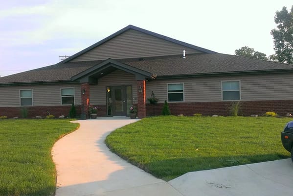 Exterior view of Allay Senior Care building with landscaping