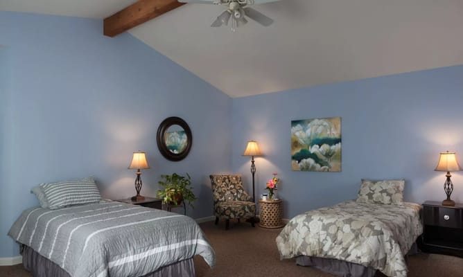 Bright interior of a resident room with two beds
