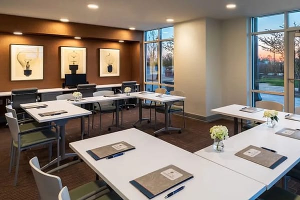 Bright meeting room with tables and flowers