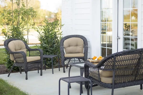 Outdoor seating area with wicker chairs and a small table