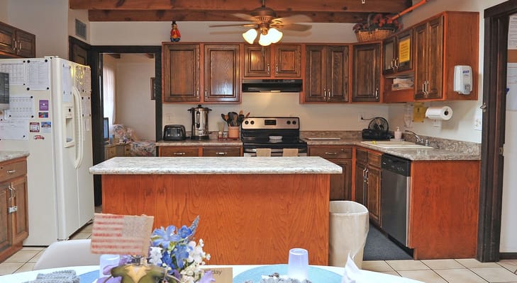 Bright kitchen area with wooden cabinets and appliances