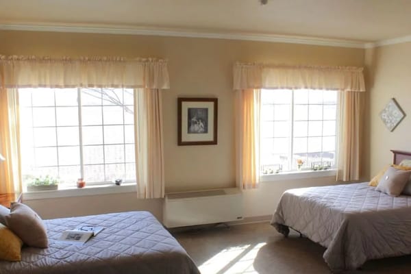 Cozy private resident room with two beds and natural light
