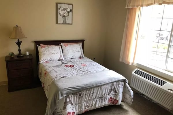 Cozy private room with a bed and lamp