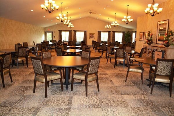 Spacious dining room with round tables and chairs