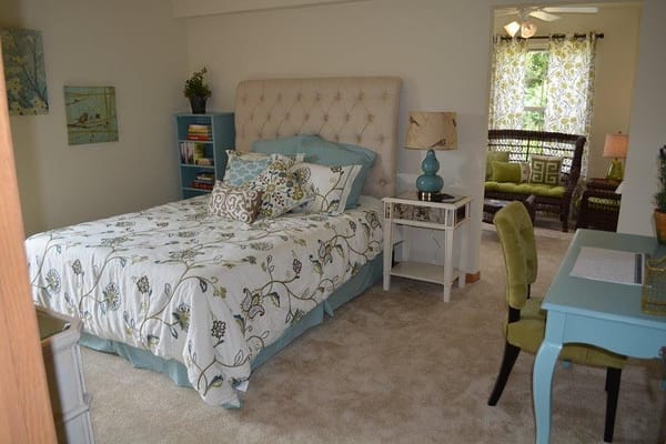 Spacious bedroom with floral bedding and natural light