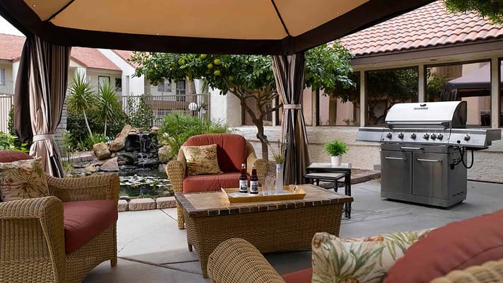 Comfortable outdoor seating area with a BBQ grill