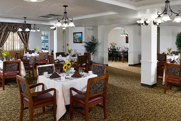 Dining room with tables set for residents
