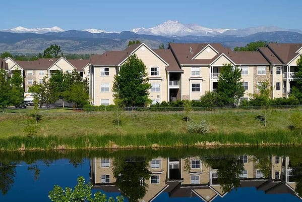 Exterior view of Atria Longmont with mountains in the background