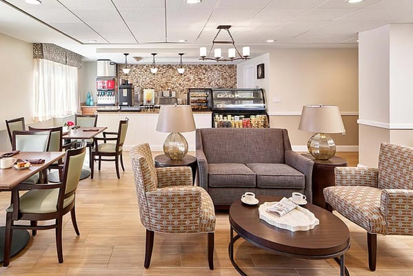 Bright common area with seating and a snack bar