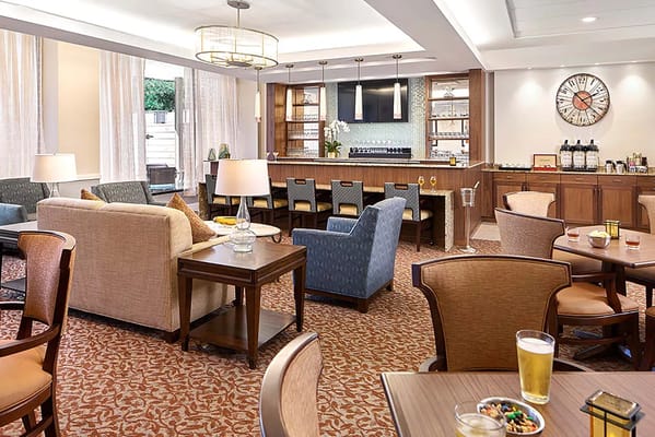 Bright common area with seating and bar