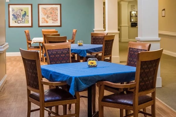 Common area with tables and chairs set for dining