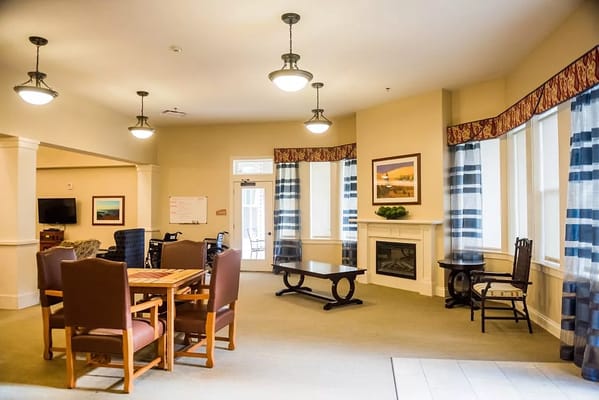 Bright common area with seating and a fireplace