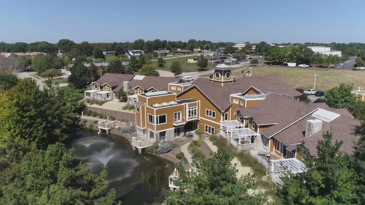 Aerial view of a senior living facility with a pond