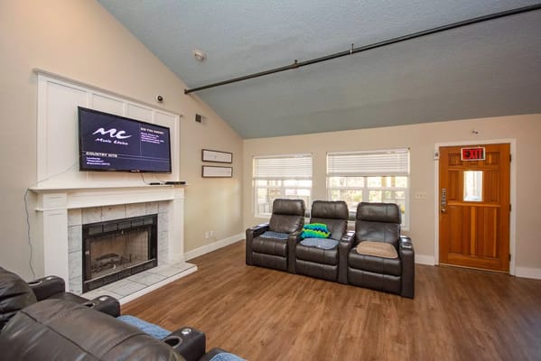 Bright common area with seating and a fireplace
