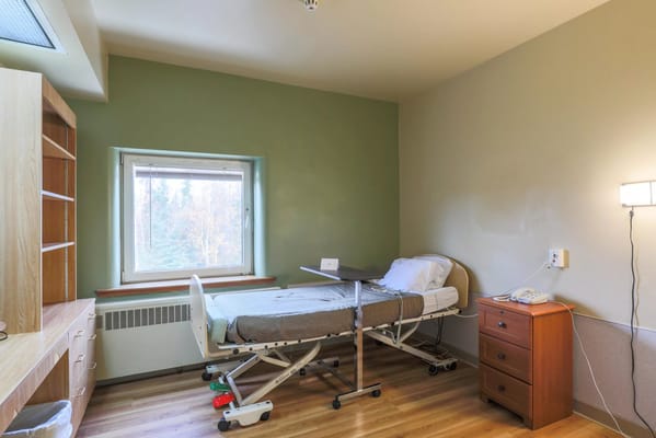 Interior view of a resident room with a hospital bed