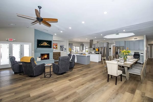 Bright and spacious common area with seating and fireplace