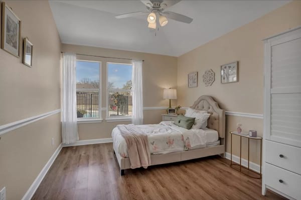 Brightly decorated resident room with bed and window