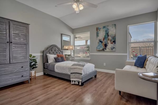 A well-furnished resident room with natural light