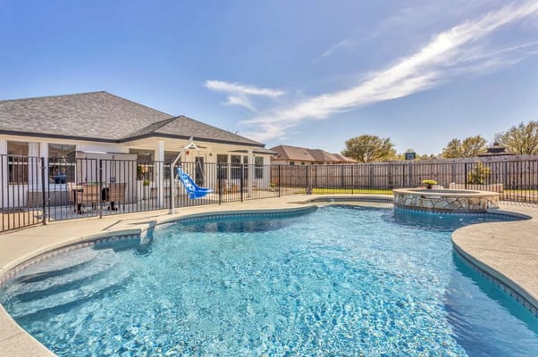 Swimming pool surrounded by outdoor seating area