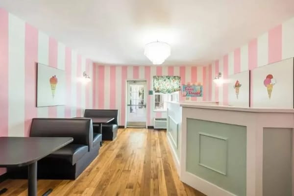 Colorful ice cream parlor with pink striped walls and seating area