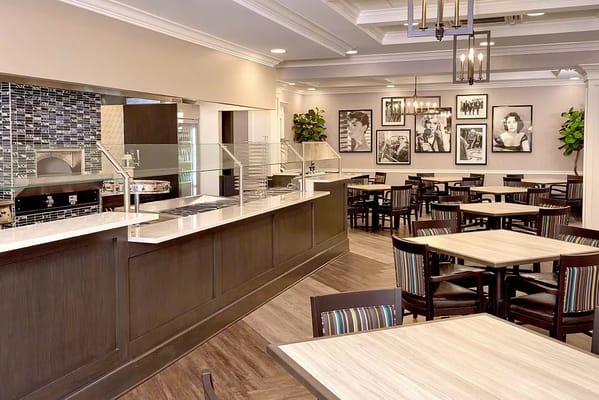Modern dining area with tables and a serving counter