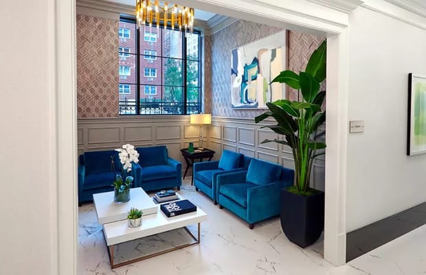 Cozy living room with blue chairs and a large window