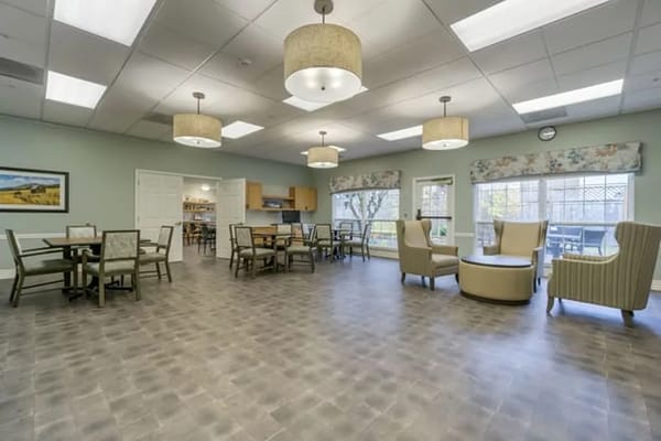 Common area with tables and chairs in a bright room