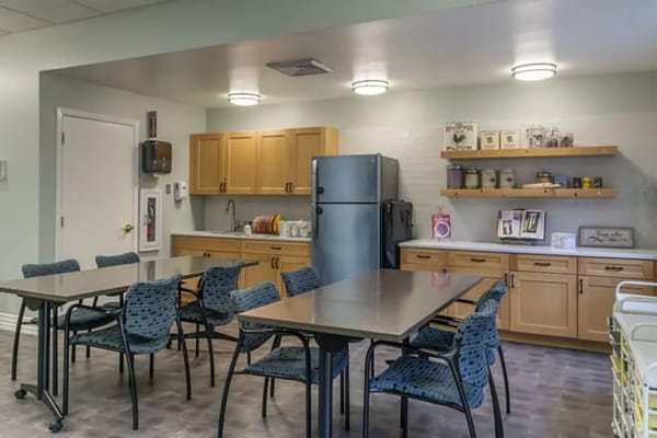 A well-lit dining area with kitchen amenities