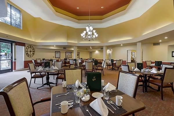 Stylish dining area set for a meal with table settings