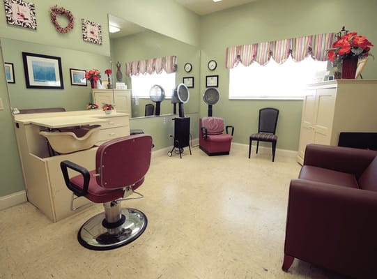 A hair salon area with chairs and mirrors