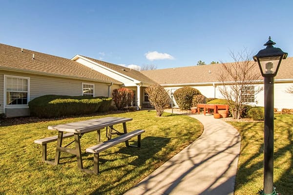 Outdoor space with benches and picnic tables in a garden