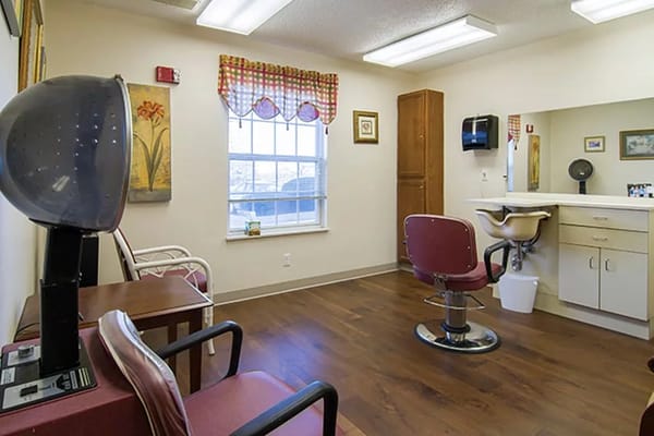 Salon area with hairdryer and styling chair