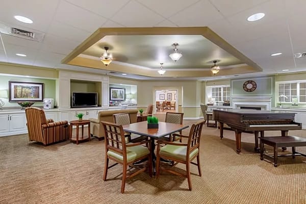 Welcoming common area with seating and a piano