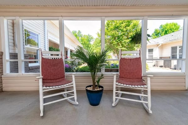 Interior seating area with rocking chairs and a plant