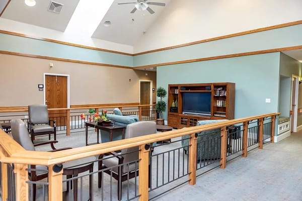 Common area with seating and TV in a nursing home
