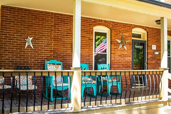 Outdoor seating area with colorful chairs and decorations