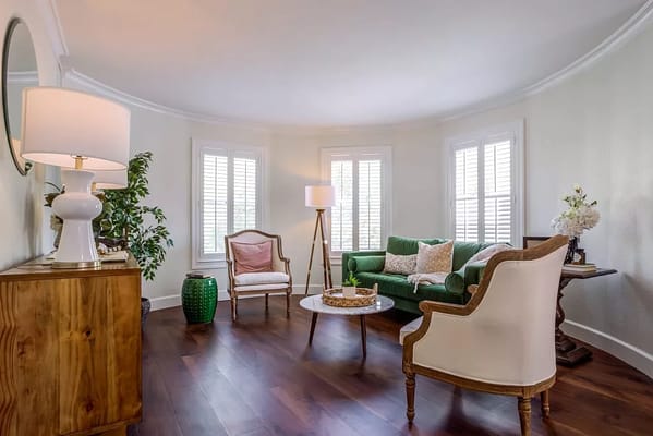 Cozy living room with green couch and wooden furniture