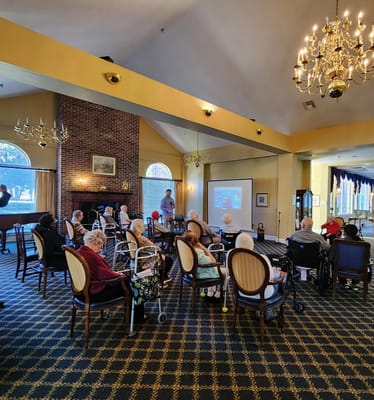 Residents enjoying a presentation in the common area