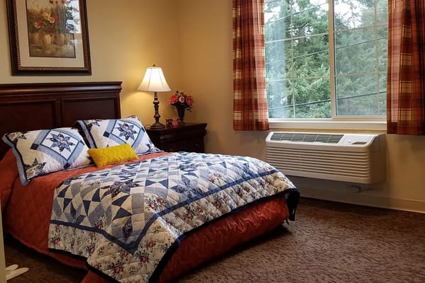 Cozy private room with a bed and window.