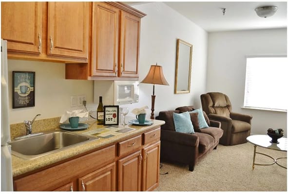 Cozy resident room featuring kitchen area and seating