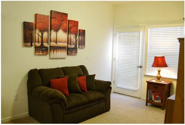 Cozy living area in a resident's room with decorative artwork