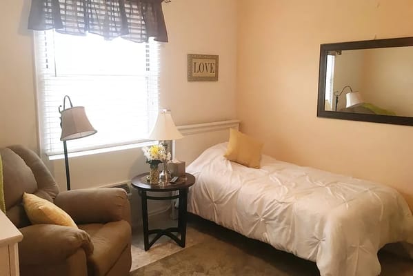 Cozy private resident room with bed and seating