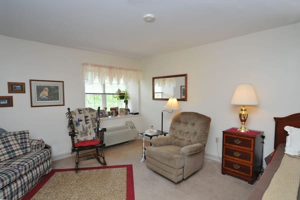 Cozy resident room with seating and personal decor