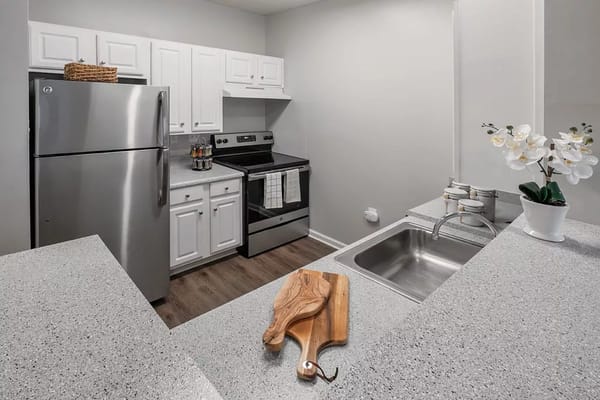 Bright kitchen with stainless steel appliances and granite countertops