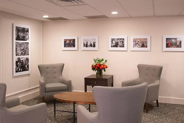Cozy lounge area with armchairs and framed photos