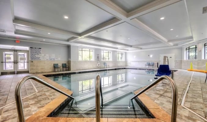 Indoor swimming pool with seating area