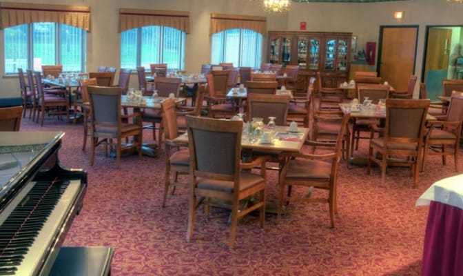 Dining area set up for a meal with tables and chairs