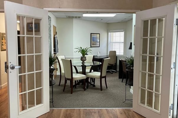 Bright office area with a glass table and chairs