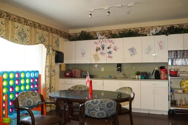 Cozy activity room with seating and games at The Club at St. Cloud